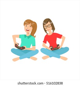 Two Teenage Girlfriends Sitting With Legs Crossed Playing Video Games With Controllers, Part Of Women Different Lifestyles Collection