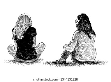 Two teenage girls sitting on the grass in a city park