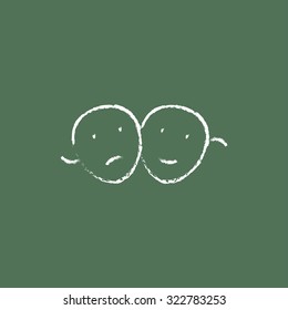 Two theatrical masks hand drawn in chalk on a blackboard vector white icon isolated on a green background.