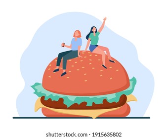 Two tiny women sitting on big burger. Bun, fat, meal flat vector illustration. Junk food and nutrition concept for banner, website design or landing web page