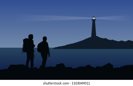 Two tourist with backpacks standing on the sea shore and watching the shining lighthouse on the island under blue night sky - vector