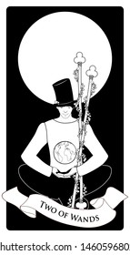 Two of wands. Tarot cards. Young man sitting, wearing hat looking at a globe.