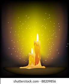 Two wax candles burning in the dark
