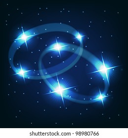 Two wedding rings beautiful bright stars on the background of cosmic sky