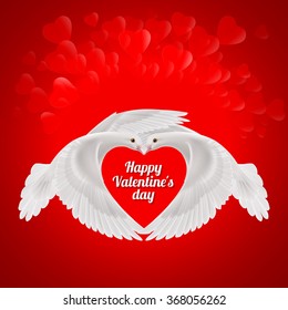 Two white doves makes the shape of the wings of the red heart. Love symbol