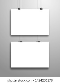 Two white sheets of paper hang on clips. Mockup in horizontal orientation