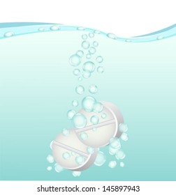 two white tablets dissolve in water with bubbles