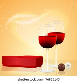 Two wine glasses and box of chocolates