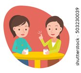 Two woman talking and drinking coffee in a cafe.