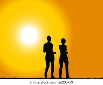 Two woman walking at sunset