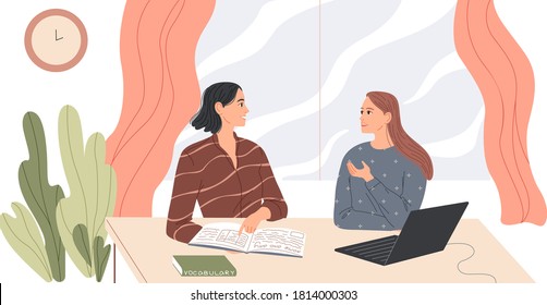 Two women sit at the desk and talk.