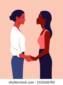 Two women stand in profile and hold hands. Feminism. Sisterhood. Community of girls of different nations. Vector flat illustration