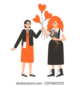 Two women stand side by side and hold red balloons in the shape of a heart for Valentine's Day