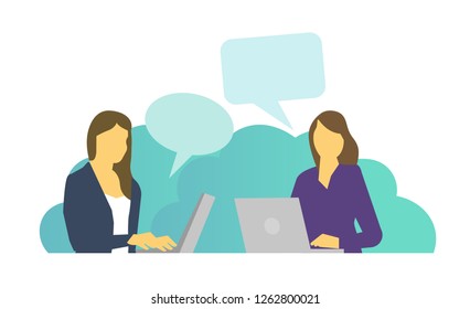 Two women work sitting at laptops and talking chatting. Everyday tasks at work at the table.