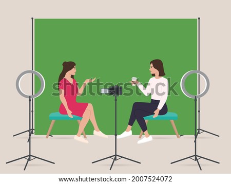Two womens live streaming show in home studio with professional equipments green screen dslr camera ring light