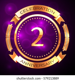 Two years anniversary celebration with golden ring and ribbon on purple background.