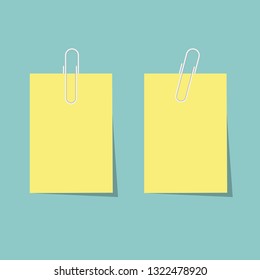 Two yellow blank note paper with white clips in pastel colors.