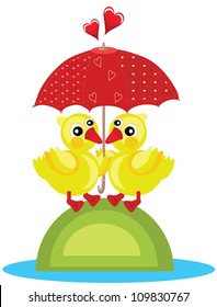 Two yellow ducks under the red umbrella