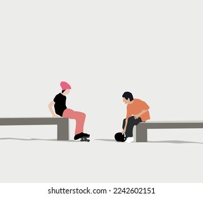 Two young boys with their skateboard sitting and having a conversation while relaxing in an urban city park. Trendy teenagers enjoying free time