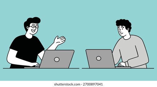 Two young men sitting at a desk, facing each other with open laptops.