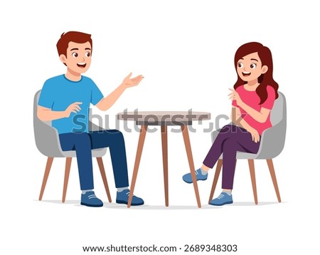 Two Young People Having a Conversation at a Table Man Explaining Something to Woman