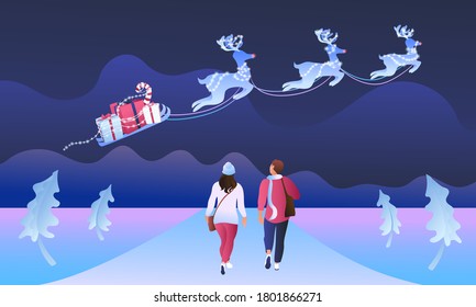 Two young people are walking under the night sky on an abstract winter background. The guy and the girl look at the deer`s with a sleigh and gifts. Christmas night, modern illustration, garlands glow.