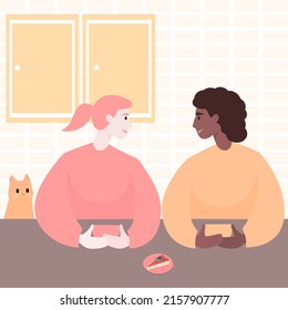 Two young women and a cat are sitting in the kitchen and talking over a cup of coffee. Boston Marriage. An international lesbian couple at home. Friends at a tea party. Flat vector illustration