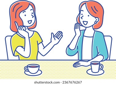 Two young women having a conversation while drinking coffee at a cafe