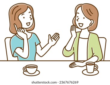 Two young women having a conversation while drinking coffee at a cafe