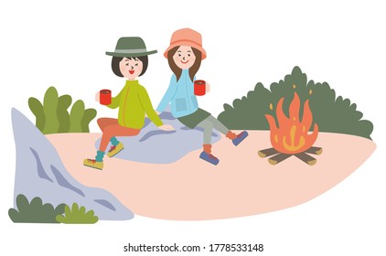 Two young women on campfire and drinking coffee