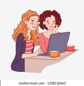 Two young women sitting at the table and looking for something on the Internet 