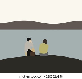 Two young women sitting and talking on rock near lake. Resting outdoors and travel. Lovely lesbian couple on holiday. Gays and lesbians. Rights and equality