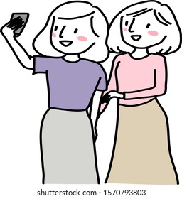 Two young women taking selfie with smartphone.