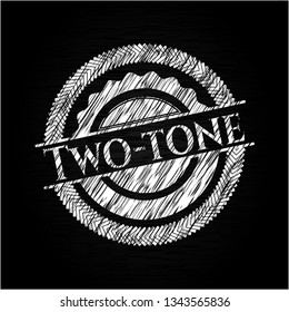 Two-tone chalk emblem written on a blackboard