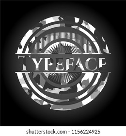 Typeface on grey camouflage texture