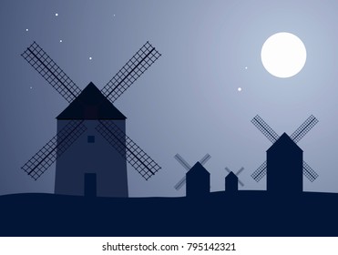 Typical Spanish windmills under the moon and stars