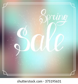 Typographic Design. Lettering Spring design on blurred background.Advertisement about the spring sale on defocused background