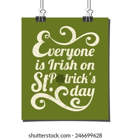Typographic style poster for St. Patrick's Day with message Everyone is Irish on St. Patrick's Day. Poster design mock-up with paper clips, isolated on white.