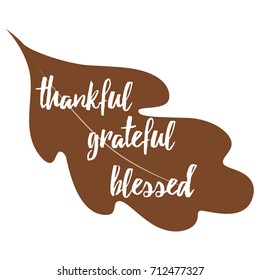 Typographic vector quote thankful, grateful, blessed decorated hand drawn acorn and oak leaf on white. Thanksgiving card. Modern calligraphy hand drawn design for greeting card, invitation, print
