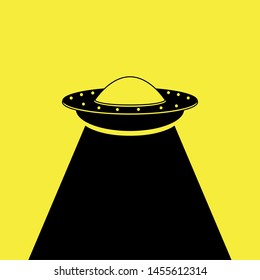 UFO. Aliens. Space ship UFO with black light on yellow background. World UFO Day. Flying saucer.  Space ship UFO ray