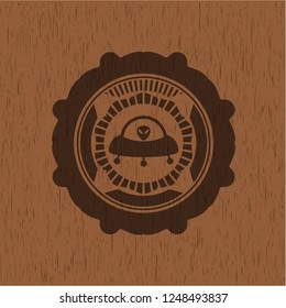 ufo with aline inside icon inside badge with wood background