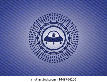 ufo with aline inside icon inside badge with denim background