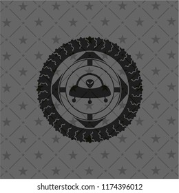 ufo with aline inside icon inside black emblem