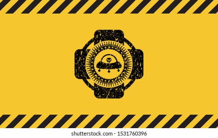 ufo with aline inside icon black grunge emblem with yellow background. Vector Illustration. Detailed.