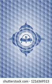 ufo with aline inside icon inside blue emblem or badge with geometric pattern background.