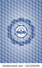ufo with aline inside icon inside blue emblem with geometric pattern.