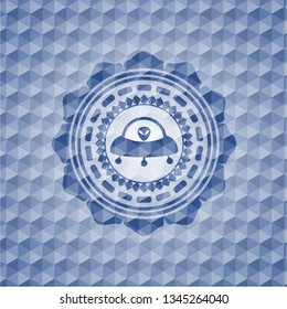 ufo with aline inside icon inside blue badge with geometric background.