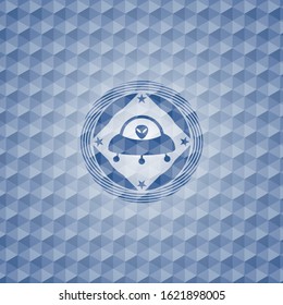 ufo with aline inside icon inside blue polygonal emblem.