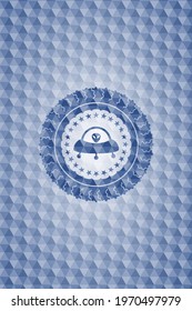 ufo with aline inside icon inside blue emblem with geometric pattern. 
