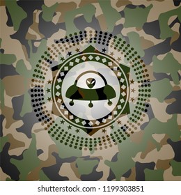 ufo with aline inside icon inside camouflaged emblem